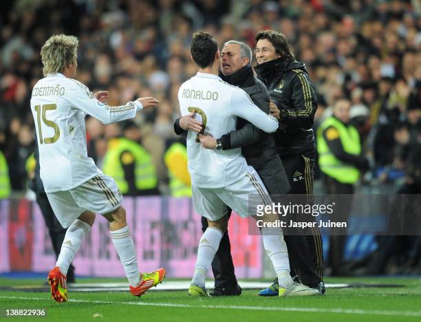 Cristiano Ronaldo of Real Madrid celebrates scoring his sides second goial with head coach Jose Mourinho as Fabio Coentrao joins in during the la...