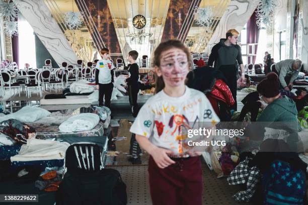 Ukranian refugees at a temporary shelter created inside the big ballroom and reception hall of the luxurious hotel Mandachi, in the Romanian town of...