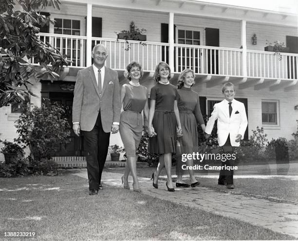 Tom Harmon family walking in front of their house holding hands. Thomas Dudley Harmon, sometimes known by the nickname "Old 98", was an American...