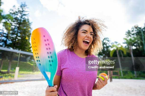 woman playing beach tennis - tennis game stock pictures, royalty-free photos & images