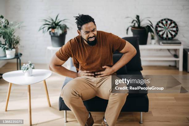 mid adult man having a stomachache - appendicitis imagens e fotografias de stock