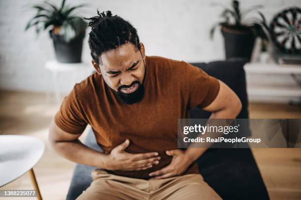 mid adult man having a stomachache - kidney stone stock pictures, royalty-free photos & images