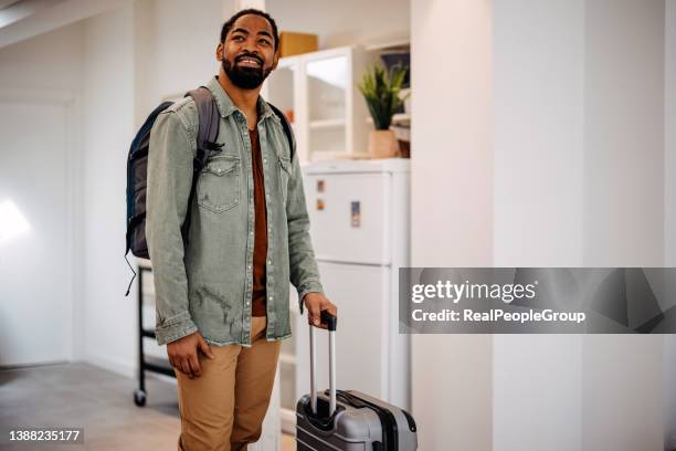 black man enters a rented apartment - backpacker apartment stock pictures, royalty-free photos & images