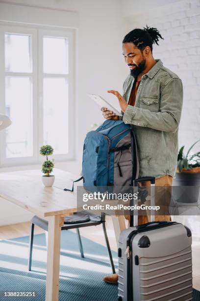 the black man enters a rented apartment through airbnb - travel real people stockfoto's en -beelden