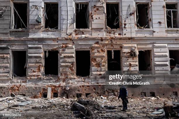 Police officer stands amongst rubble in front of a building that was destroyed by a Russian attack approximately two weeks ago on March 28, 2022 in...