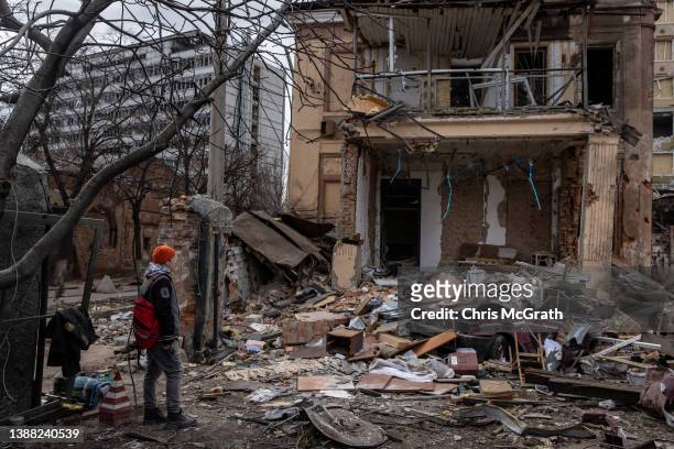 Man looks at a destroyed building that was hit by a Russian attack approximately two weeks ago on March 28, 2022 in Kharkiv, Ukraine. More than half...