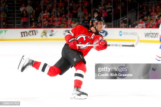 Jack Hughes of the New Jersey Devils follows through after shooting against the Montreal Canadiens on March 27, 2022 at the Prudential Center in...