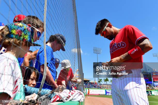 Nick Castellanos of the Philadelphia Phillies signs autographs for fans prior to a Grapefruit League spring training game against the Baltimore...