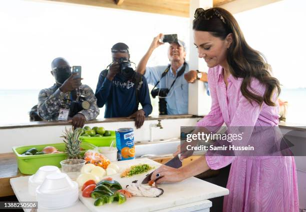 Catherine, Duchess of Cambridge prepares a conch salad during a visit to Abaco on March 26, 2022 in Great Abaco, Bahamas. Abaco was dramatically hit...