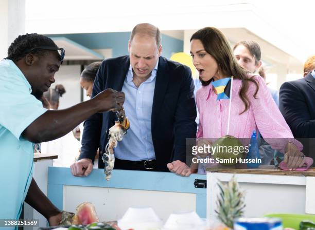 Prince William, Duke of Cambridge and Catherine, Duchess of Cambridge have a conch prepared for them during a visit to Abaco on March 26, 2022 in...