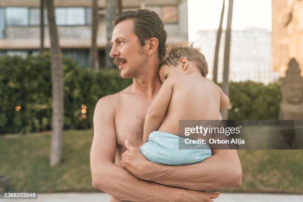 father and son at the pool - mexican mustache stock pictures, royalty-free photos & images