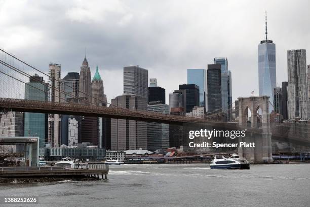 The Manhattan skyline looms over the East River on March 28, 2022 in New York City. According to the U.S. Census Bureau, New York City saw a...