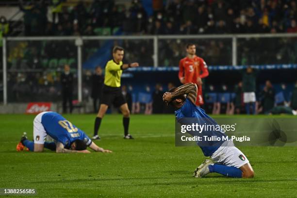 Alessandro Bastoni and Joao Pedro Galvao of Italy look dejected during the 2022 FIFA World Cup Qualifier knockout round play-off match between Italy...