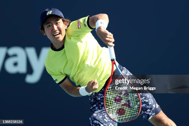 Yoshihito Nishioka of Japan returns a shot to Lloyd Harris of South Africa during the Men's Singles match on Day 8 of the 2022 Miami Open presented...