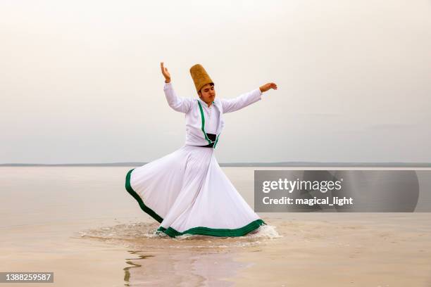 sunset and whirling at the sea, sufi. sufi whirling (turkish: semazen) is a form of sama or physically active meditation which originated among sufis. - soefisme stockfoto's en -beelden