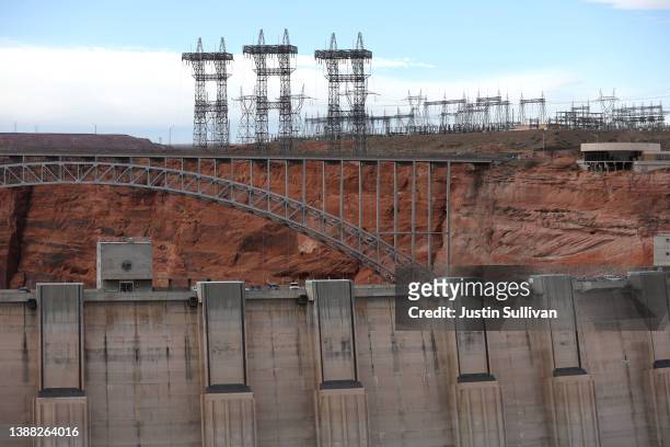 Electrical transmission towers stand near the Glen Canyon Dam at Lake Powell on March 28, 2022 in Page, Arizona. As severe drought grips parts of the...