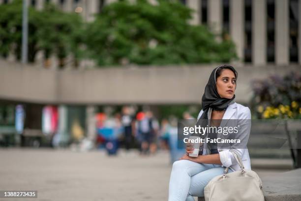 muslim woman in the city - afghani stock pictures, royalty-free photos & images