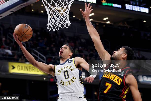 Tyrese Haliburton of the Indiana Pacers attempts a shot while being guarded by Timothe Luwawu-Cabarrot of the Atlanta Hawks in the second quarter at...