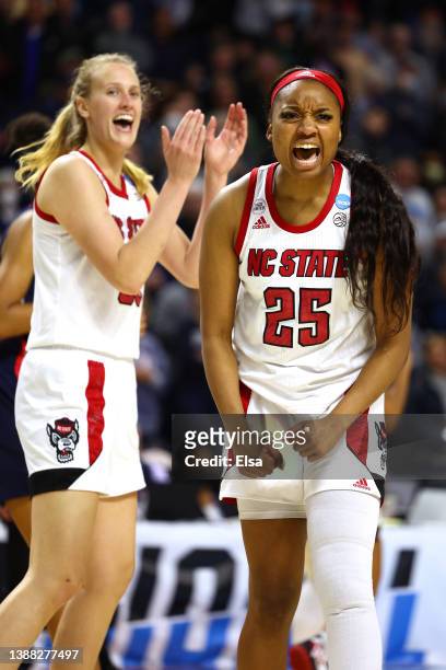 Kayla Jones and Elissa Cunane of the NC State Wolfpack celebrate after a play during the second half against the UConn Huskies in the NCAA Women's...