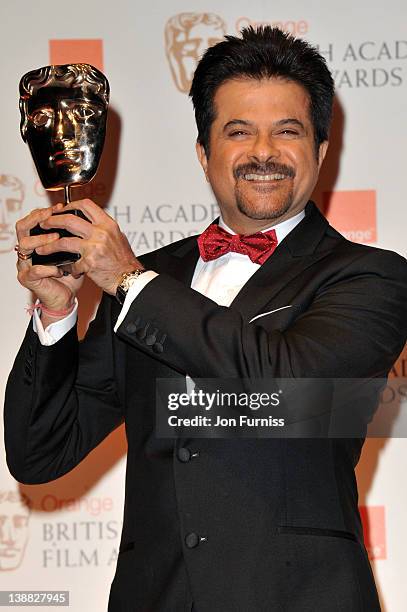 Anil Kapoor poses in the press room with the Film Not in The English Language award for "The Skin I Live In" on behalf of Pedro Almodovar during the...