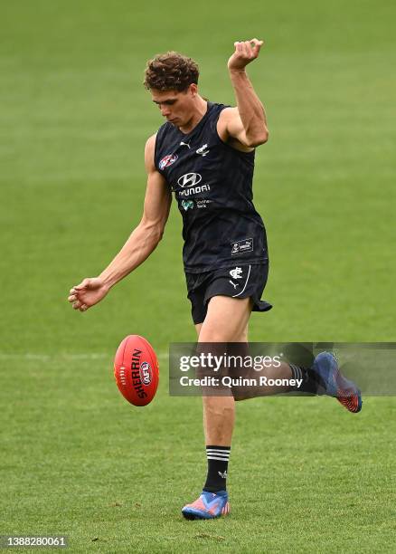 Charlie Curnow of the Blues kicks during a Carlton Blues AFL training session at Ikon Park on March 29, 2022 in Melbourne, Australia.