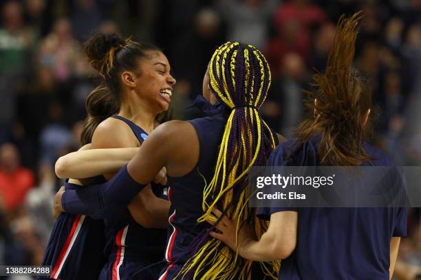 Evina Westbrook of the UConn Huskies celebrates with Aaliyah Edwards after defeating the NC State Wolfpack 91-87 in 2 OT in the NCAA Women's...