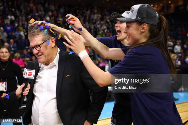 UConn Huskies players dump confetti on head coach Geno Auriemma after defeating the NC State Wolfpack 91-87 in 2 OT in the NCAA Women's Basketball...