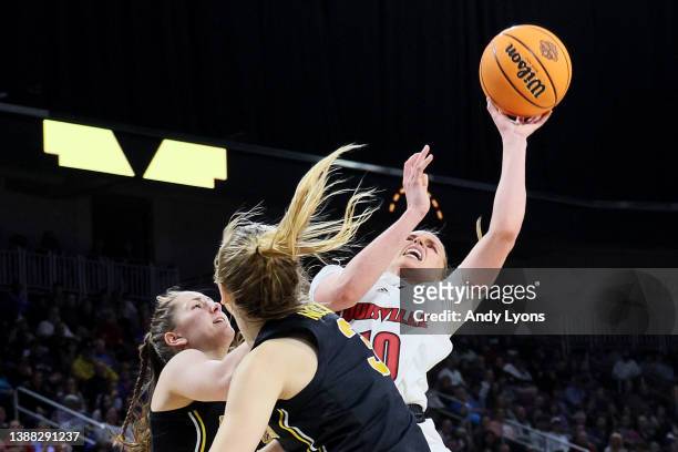 Hailey Van Lith of the Louisville Cardinals drives to the basket against Danielle Rauch and Maddie Nolan of the Michigan Wolverines during the second...