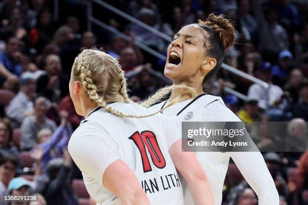Hailey Van Lith of the Louisville Cardinals celebrates with Kianna Smith after a basket against the Michigan Wolverines during the second half in the...