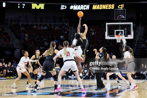 Olivia Cochran of the Louisville Cardinals wins the tip-off against the Michigan Wolverines to start the first half in the Elite Eight round game of...