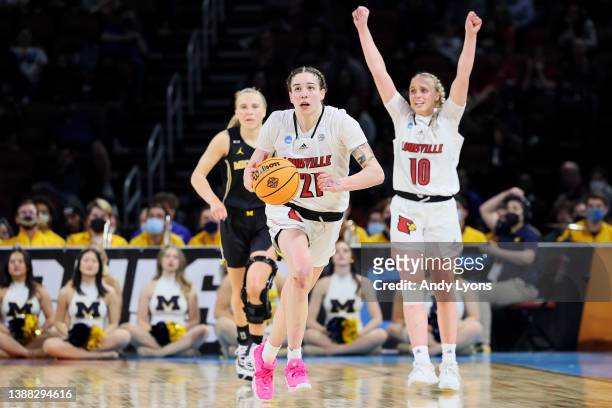Emily Engstler and Hailey Van Lith of the Louisville Cardinals react during the final seconds of the second half in the Elite Eight round game of the...