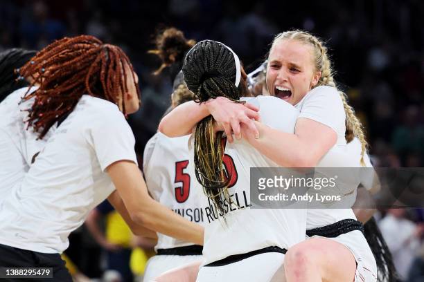 Hailey Van Lith of the Louisville Cardinals celebrates with Merissah Russell after the 62-50 win over the Michigan Wolverines in the Elite Eight...