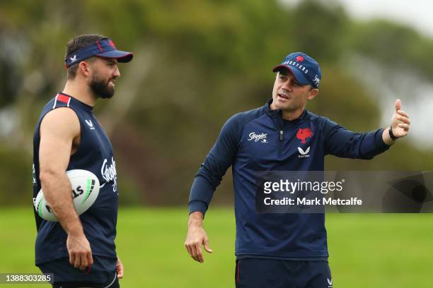 James Tedesco talks with Cooper Cronk during a Sydney Roosters NRL training session at Kippax Lake on March 29, 2022 in Sydney, Australia.
