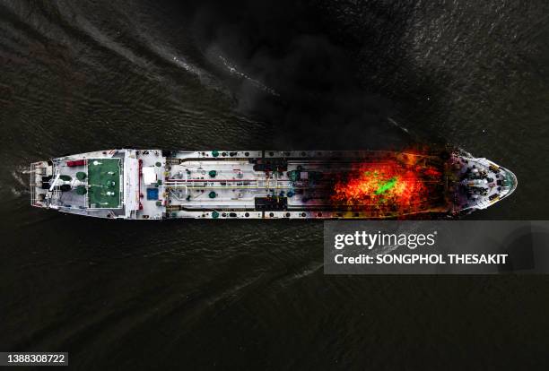 aerial view/an oil tanker explodes and catches fire on its way to deliver oil. - safety equipment stock pictures, royalty-free photos & images