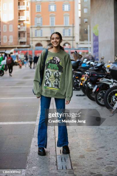 Brazilian model Caterina Guedes wears a green Pink Floyd sweatshirt, blue jeans, and black boots after the Del Core show at Bocconi University during...