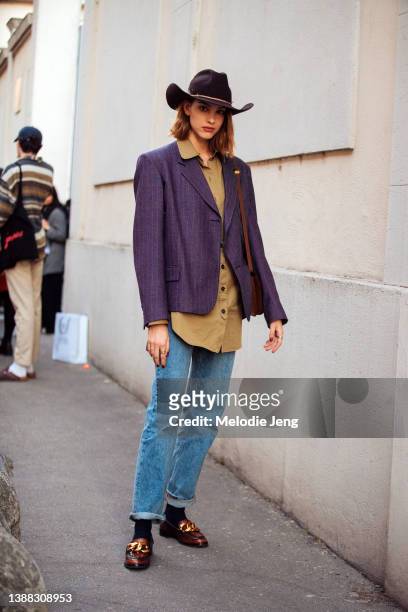 Model Giulia Theller wears a brown cowboy hat, purple blazer, olive top, blue jeans, black socks, and brown and gold chunky loafers after the Alberta...
