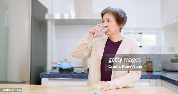 asian elderly woman take medicine - medicare supplement stock pictures, royalty-free photos & images