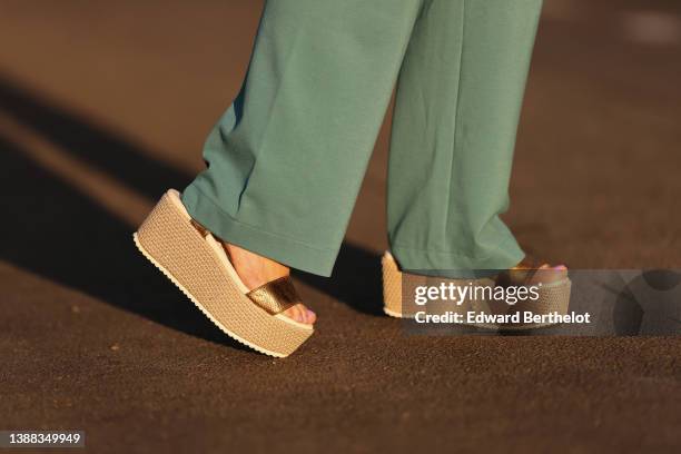 Maria Rosaria Rizzo wears high waist green wide legs / palazzo pants from Valentina Sha, brown shiny leather large strap with beige platform wicker...