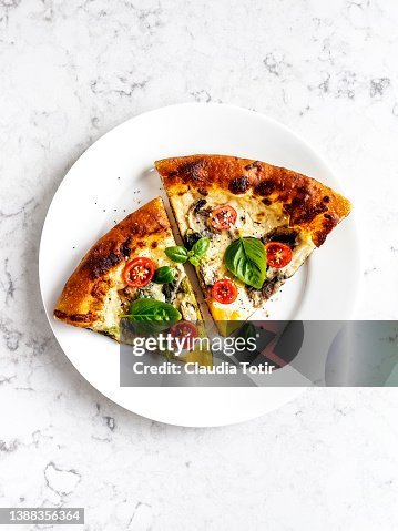 Slices of pizza on a plate on white background Slices of pizza on a plate on white background