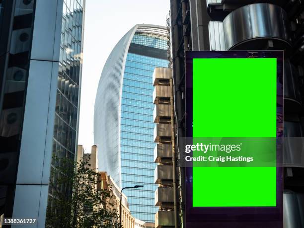 close-up low angle view of empty chroma key advertisement billboard commercial sign in a city business skyscraper office block real estate setting. concept for retail, economy and business growth, digital display, communication and marketing topics. - technology home real stock-fotos und bilder