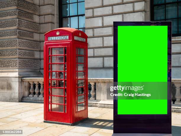 london iconic red phone box scene - close-up - low angle view  of empty chroma key advertisement billboard commercial sign. concept for retail, economy and business growth, travel, tourism and marketing topics. - london landmark ストックフォトと画像