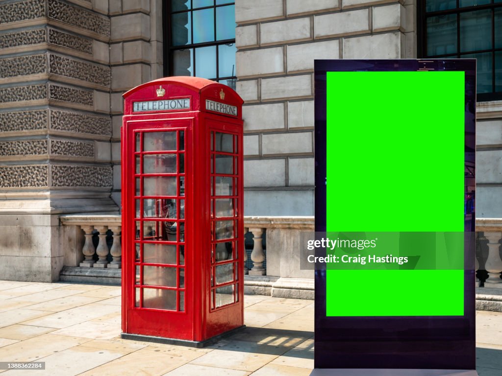 London Iconic Red Phone Box Scene - Close-Up - Low angle view Of Empty Chroma Key Advertisement Billboard Commercial Sign. Concept For Retail, Economy and Business Growth, Travel, Tourism And Marketing Topics.