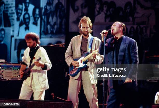 Bassist Daryl Stuemer, guitarist Mike Rutherford, singer Phil Collins of the band Genesis perform during the Atlantic Records 40th Anniversary...