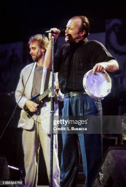 Guitarist Mike Rutherford and singer Phil Collins of the band Genesis perform during the Atlantic Records 40th Anniversary celebration called "Its...