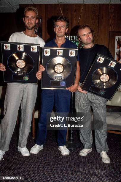 Musicians Mike Rutherford, Tony Banks and singer Phil Collins of the band Genesis, receive platinum album sales plaque in support of their album "The...