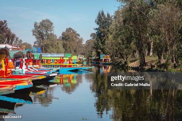 xochimilco channels full of colorful boats - xochimilco stock pictures, royalty-free photos & images