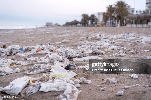 beach full of garbage, wet wipes and waste that people throw in the toilet. concept of ocean pollution and environmental destruction, málaga, spain. - wet wipe stock pictures, royalty-free photos & images