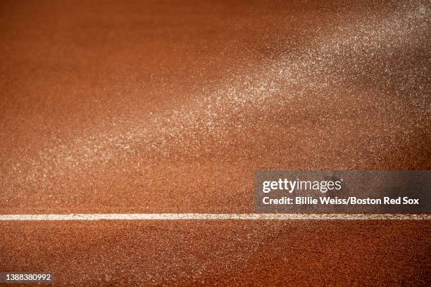 The dirt is sprayed with a hose during a Grapefruit League game between the Boston Red Sox and the Minnesota Twins on March 23, 2022 at jetBlue Park...