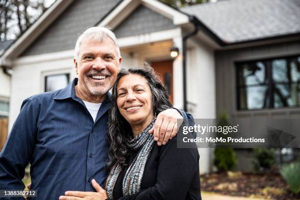 portrait of senior couple in front of home - casal idosos imagens e fotografias de stock