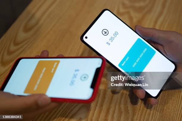 asian man using smartphone to transfer money - near field communication stock pictures, royalty-free photos & images